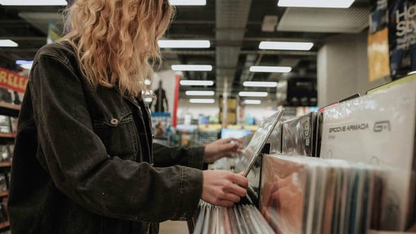 A woman browsing records in a record store, ca. 2000s.